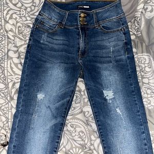 These are a size 3 tight fitting Fashion Nova three button ripped jeans.